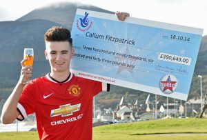 WHO'S A LUCKY BOY...Callum Fitzpatrick with his winning cheque for £390,000