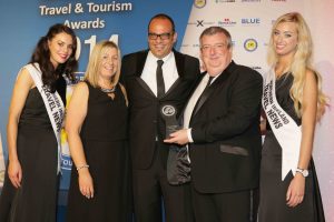 Peter McMinn, MD of Travel Solutions and Julie Magill, Operations Director of Travel Solutions receive their award for Best Short Break Tours Operator from Peter Friedrich of TravelCube