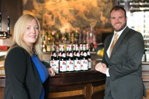 CHEERS… Manager of Berts Jazz Bar Lucy McConville and Gavin Carroll from The Merchant Hotel receive delivery of this year’s new vintage Beaujolais Nouveau 2014.