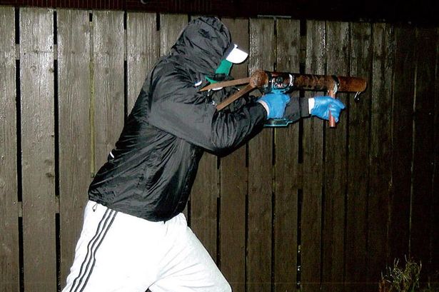 Man holding makseshift rocket similar to one used to attack police