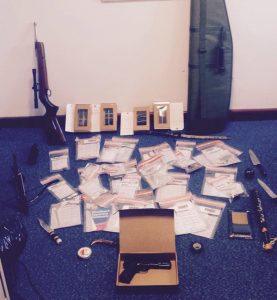 Police put on display the guns, knives, mobile phones and other paraphernalia seized in north Belfast raid