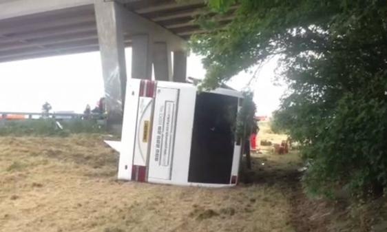 The overturned Richmond coach which crashed into a motorway bridge pillar