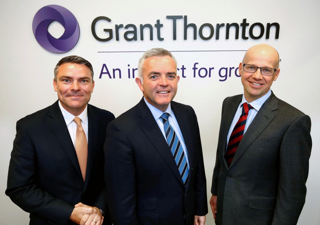 Pictured with Minister Jonathan Bell at the company offices are Mark Cardiff, Head of Audit, Grant Thornton UK LLP and Richard Gillan, Partner in Charge, Grant Thornton NI LLP.Photographer William Cherry / Press Eye. 