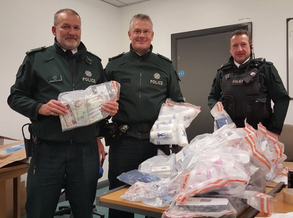 Constables Kirk, Nixon and Withers from the Castle Neighbourhood team with some of the cash and suspected steroids seized during the searches lead by Inspector Watton.