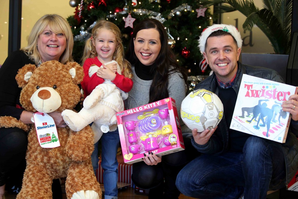 Little Cerys ONeill (4), joins Diane Poole of Stena Line and Rebecca McKinney and Pete Snodden from Cool FM as they get ready to donate a toy to the Cash for Kids festive Mission Christmas toy campaign at the Stena Line Victoria Terminal 4 drop off point in Belfast.