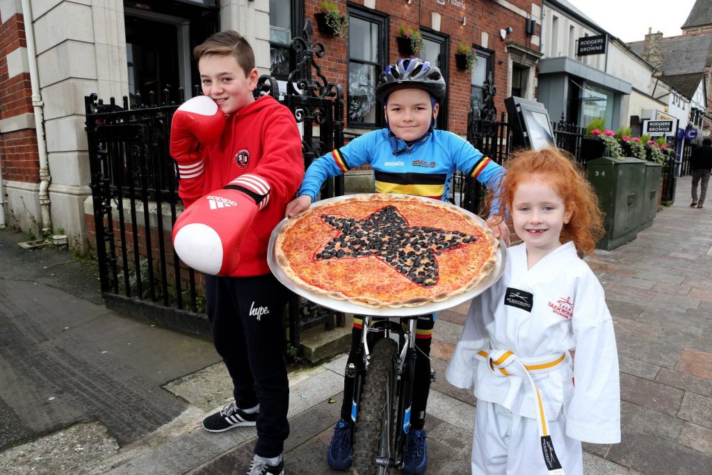 Lauren Rogers from Holywood Tae Kwon Do, Declan Uprichard from St John Bosco Amateur Boxing Club in West Belfast and Oran Anderson from VC Glendale Cycling Club in South Belfast celebrate as their clubs were named as winners in the Little Wing Little Stars bursary programme. A total of £3000 has been awarded in bursaries to seven children’s clubs across Northern Ireland by Little Wing Pizzeria as a way of providing vital support to community based clubs. 