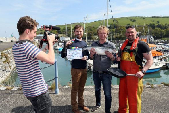 PIC Dutch chef and Food Tube presenter Bart van Olphen (second right); director Tim van Niftrik (left); Des Burke, Tourism Ireland (second left); and Nigel McClure, Glenarm Organic Salmon, at Glenarm Harbour. Pic – Paul Faith 