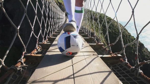 Carrick-a-Rede Rope Bridge, Co Antrim – With kick-off to the European Championship nearly upon us, Tourism Ireland today launched its Euro 2016 campaign, to capitalise on the tourism potential of the tournament. PIC SHOWS: Freestyle footballer Jamie Knight in action on the Carrick-a-Rede Rope Bridge. Pic – Tourism Ireland 