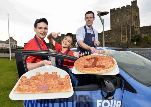 CASTLE DO NICELY!!! (l-r) Teofil-Stefan Sorban, Emma Gaw and Mark Givens (manager) of Four Star Pizza in Carrick celebrate the restaurant’s first birthday with their very own Carrickfergus Castle pizza creation.  The store officially opened its doors on Marine Highway in September 2015 as part of a £150,000 investment which has created 20 jobs in the area