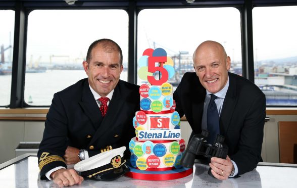 HIGH FIVE...Stena Lines Cpt Alistair McCarlie and Onboard Sales and Service Manager Stephen Bryden celebrate five years of Stena Lines Belfast Cairnryan ferry service. Since the opening