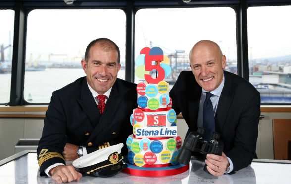 HIGH FIVE...Stena Lines Cpt Alistair McCarlie and Onboard Sales and Service Manager Stephen Bryden celebrate five years of Stena Lines Belfast  Cairnryan ferry service. Since the opening 